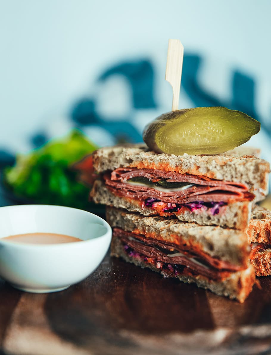 Close-up of salami sandwich with sauce on the table, bacon, bowl HD wallpaper