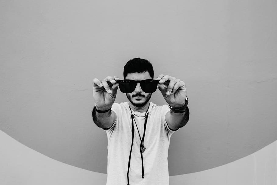 man holding sunglasses, one person, front view, waist up, real people HD wallpaper