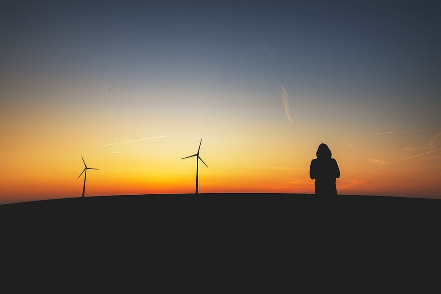 Silhouttte Photography of Person Standing Near Turbines, alternative