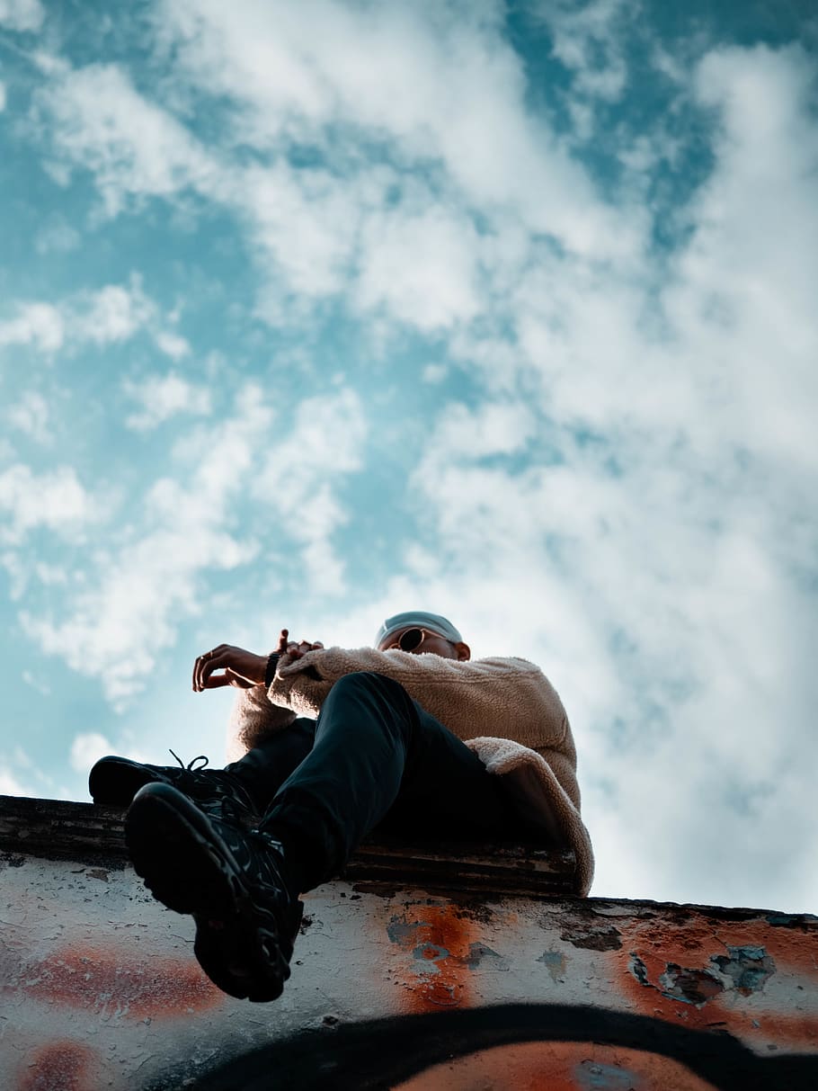 HD wallpaper: worm's eye view of man sitting on pavement, cloud - sky ...