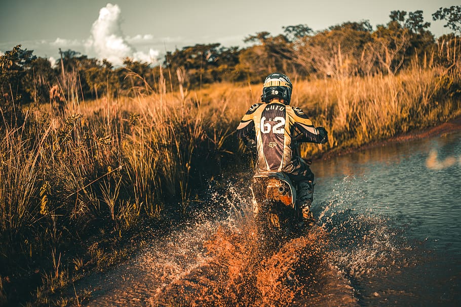 Person Riding Dirt Bike in Middle of River, biker, clouds, daylight HD wallpaper