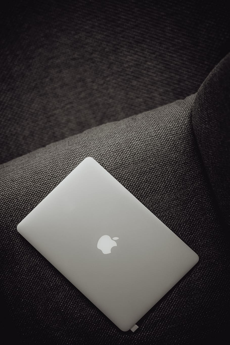 Close up view of closed laptop lying on grey armchair, tech, computer, HD wallpaper