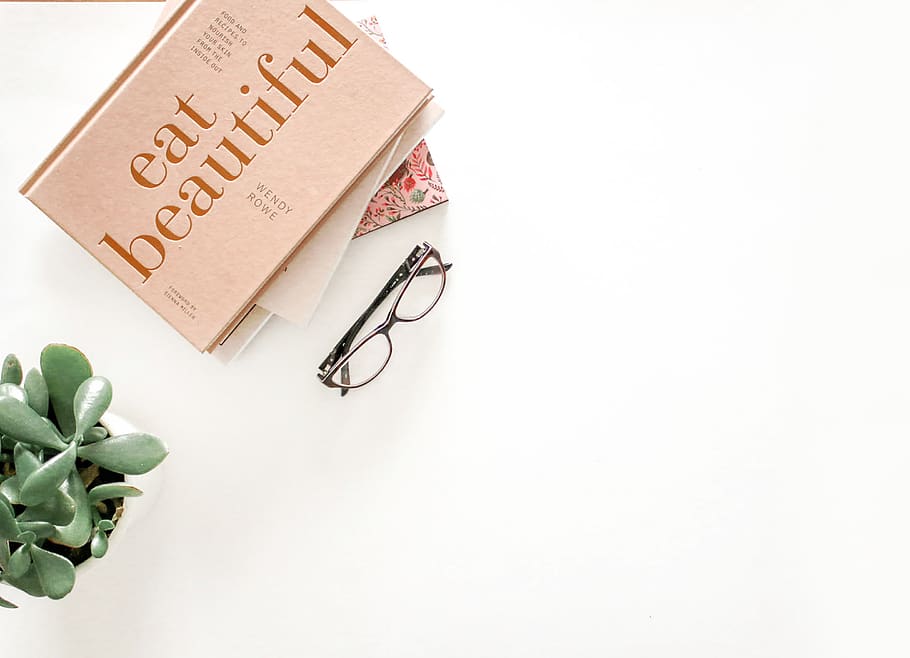 Brown Framed Eyeglasses Beside Eat Beautiful Book, books, design