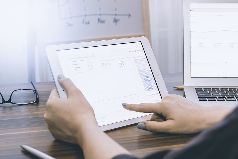 Business person analyzing Google Analytics on tablet, computer HD wallpaper