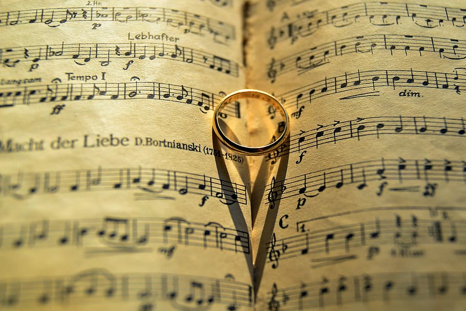 Gold-colored Ring on Musical Note, blur, calligraphy, clef, close-up
