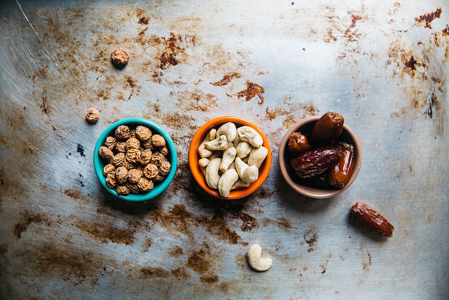 cashew, nuts, peanuts, prunes, bowl, raisins, table, dirt, food HD wallpaper