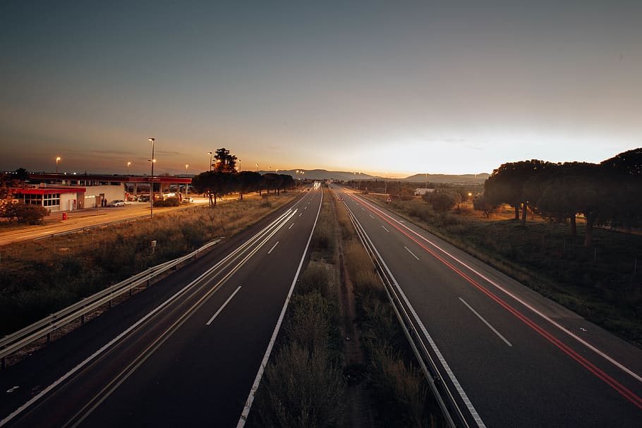 Two Asphalt Roads, dark, evening, expressway, golden horizon HD wallpaper