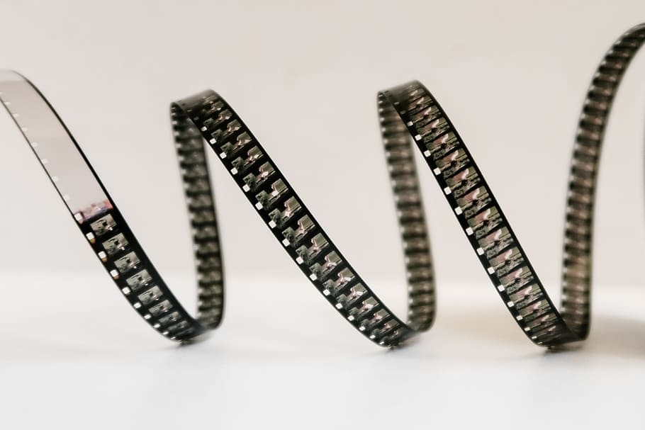 black and white strap on white surface, film, film strip, film reel