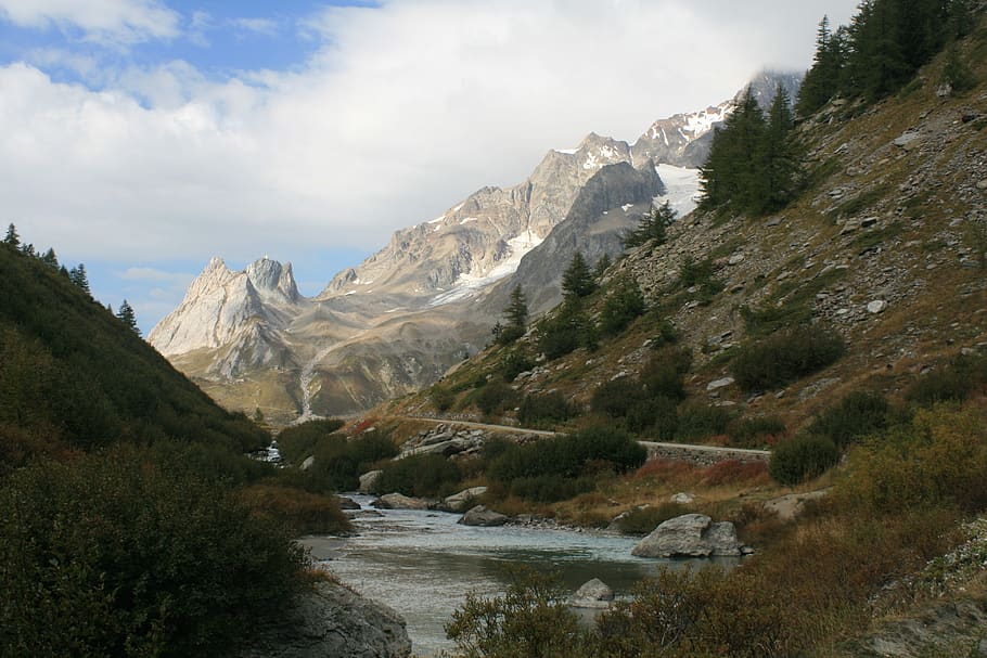 alps, stream, mountains, snow caps, valley, sky, beauty in nature HD wallpaper