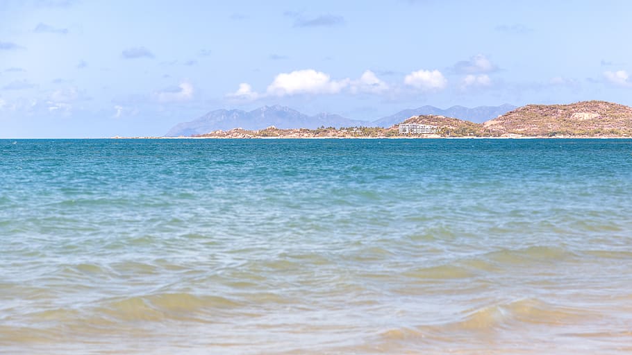 ocean, waves, hotel, building, apartment, island, hill, mountain HD wallpaper