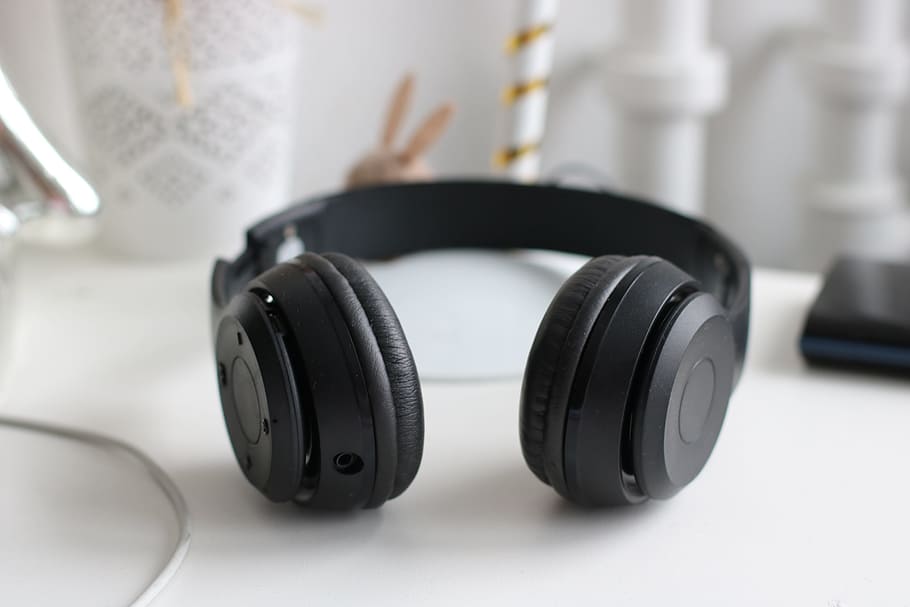 Black Cordless Headphones, desk, electronics, music, plastic HD wallpaper