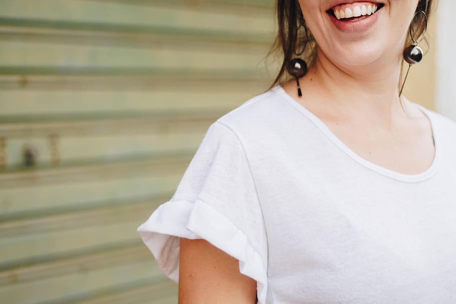 woman standing in front of rolling shutter, person, teeth, smile HD wallpaper