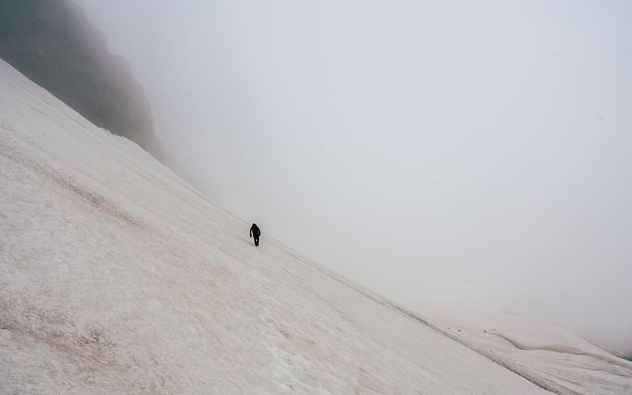 man walking on snow-covered field, cold temperature, winter, mountain HD wallpaper