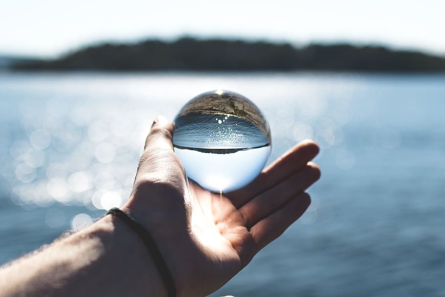 Bokeh Photography of Person Holding Water Drop, outdoors, reflection HD wallpaper