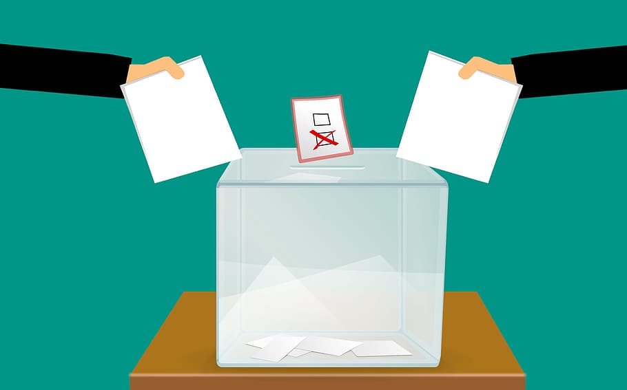 Votes being cast at a ballot box on election day. Illustration.