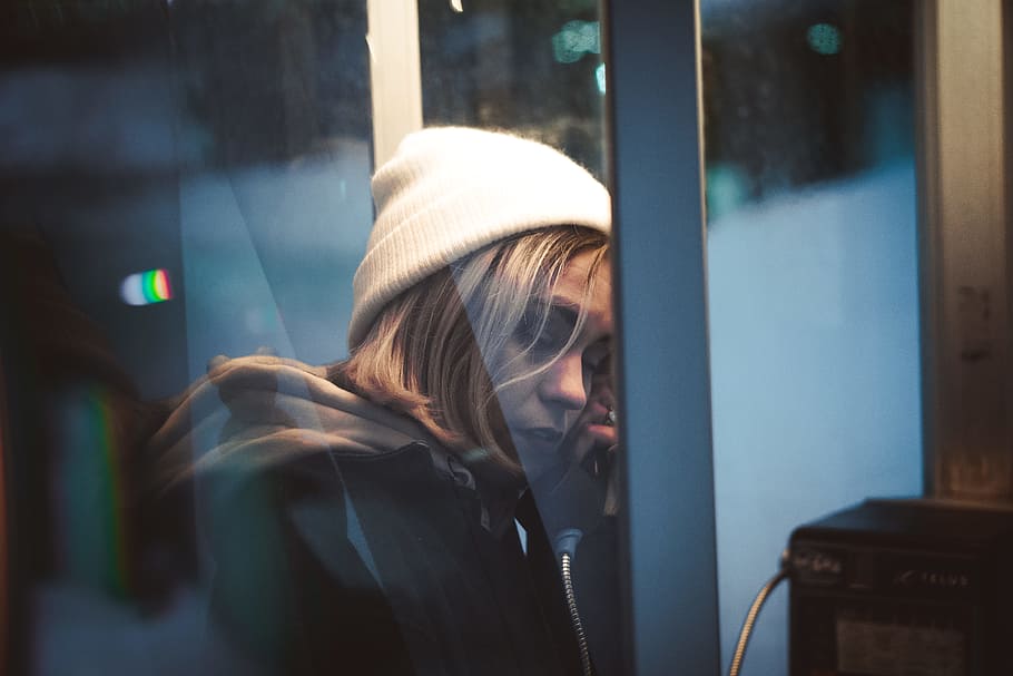 woman in telephone booth, female, beanie, fashion, style, talking