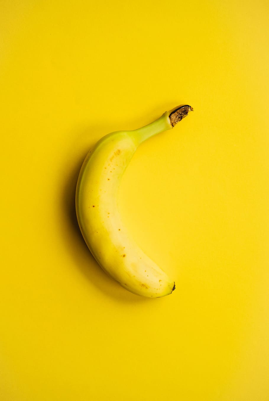 yellow banana fruit on yellow surface, yellow background, unporn