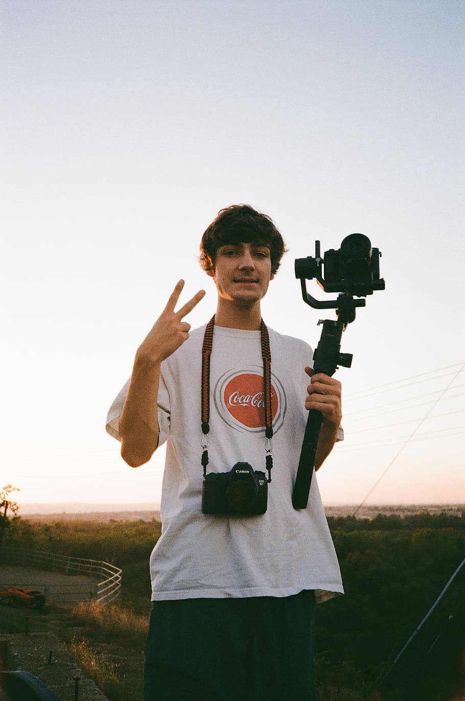 man holding camera with gimbal, sky, real people, standing, one person HD wallpaper