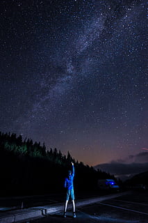 Man Pointing At The Sky Using His Right Index Finger At Night HD wallpaper