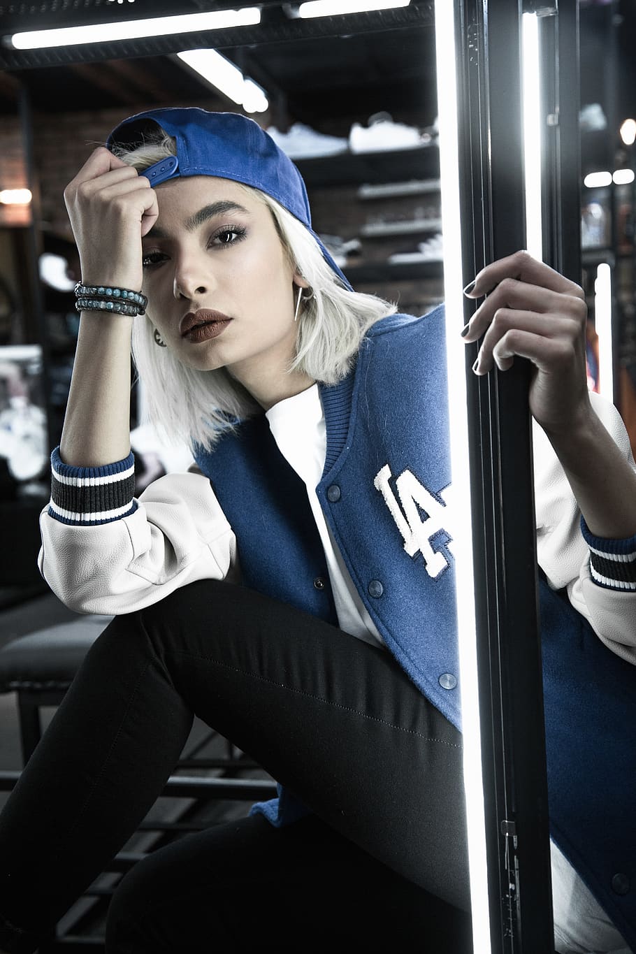 shallow focus photo of woman in blue and white LA Dodgers letterman jacket