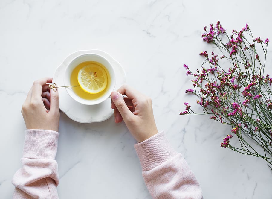 tea, table, flowers, hands, cup and saucer, lemon, fruit, hot drink HD wallpaper