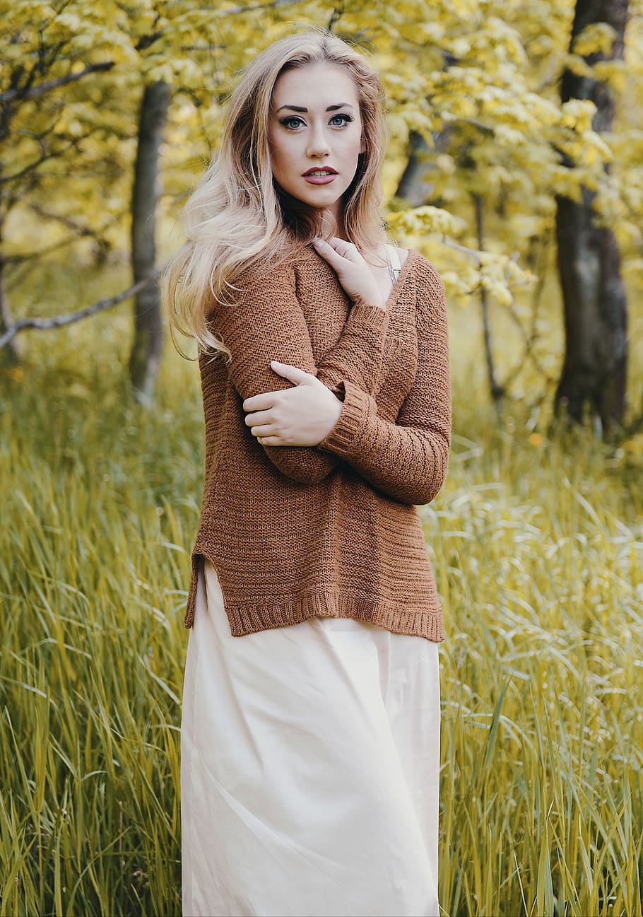 woman wearing brown sweater standing on green grass field, clothing, HD wallpaper