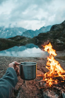 person holding mug, cup, camping, camp mug, fire, campfire, lake HD wallpaper