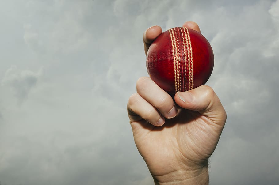 cricket, cricket ball, red, hand, sky, cloud, human hand, human body part