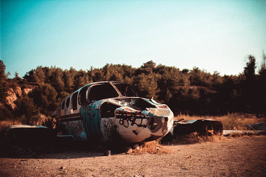 wrecked plane on ground, road, gravel, dirt road, vehicle, car