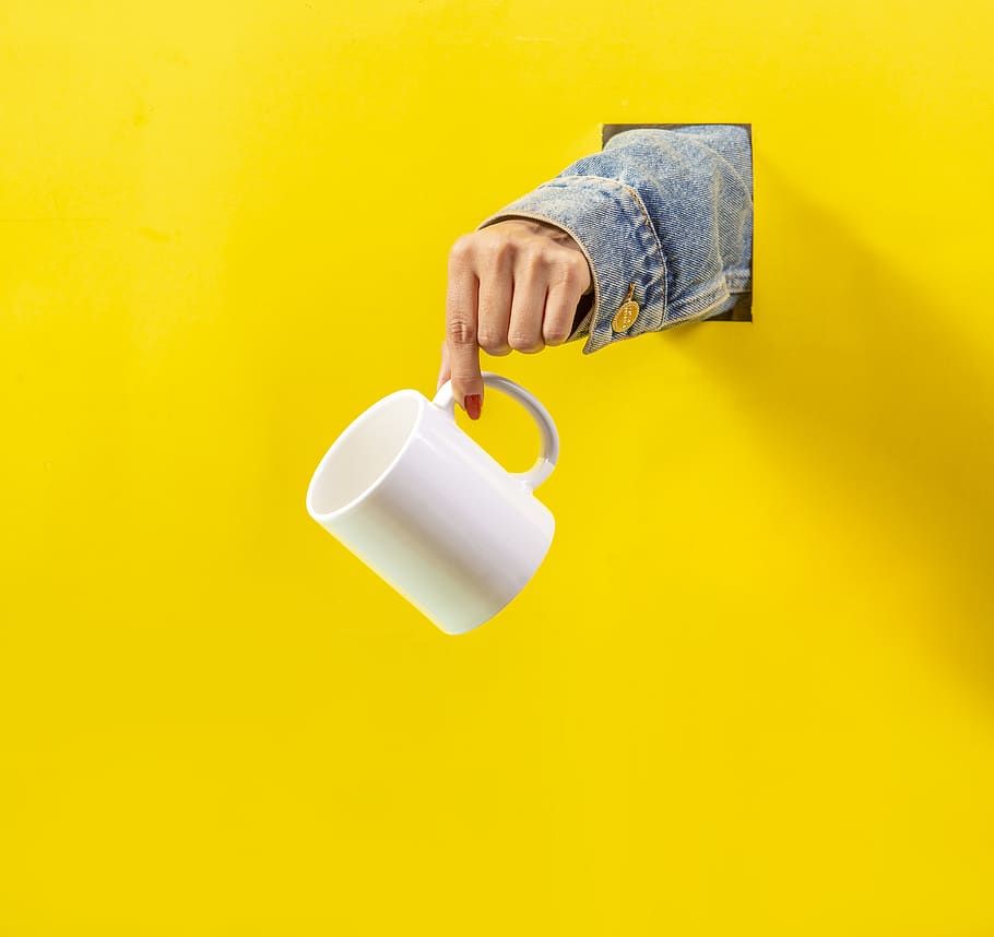 white ceramic mug, yellow, human hand, human body part, colored background HD wallpaper