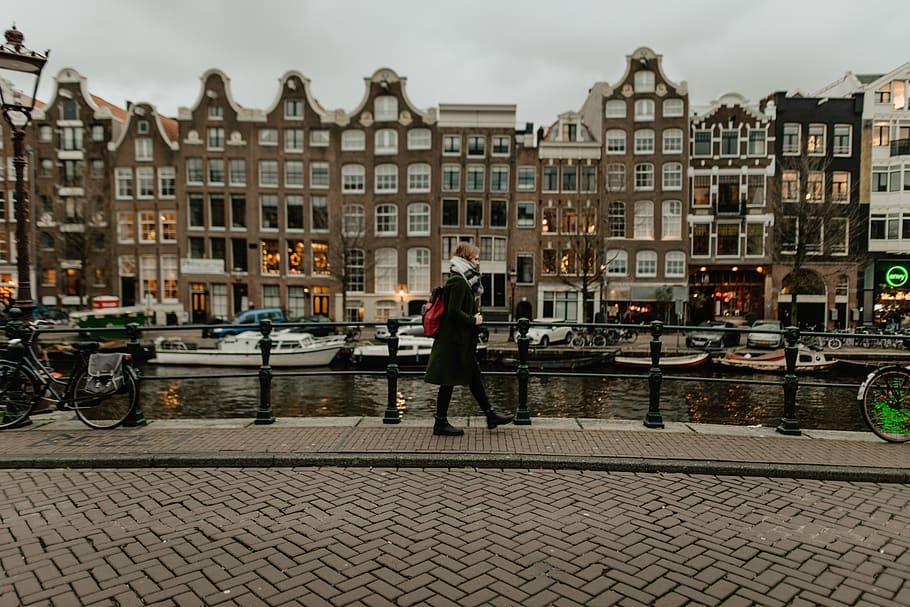 woman walking beside canal, city, human, pedestrian, person, building, HD wallpaper