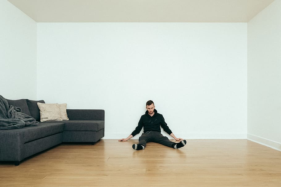 man sitting beside sofa, indoors, flooring, full length, living room HD wallpaper