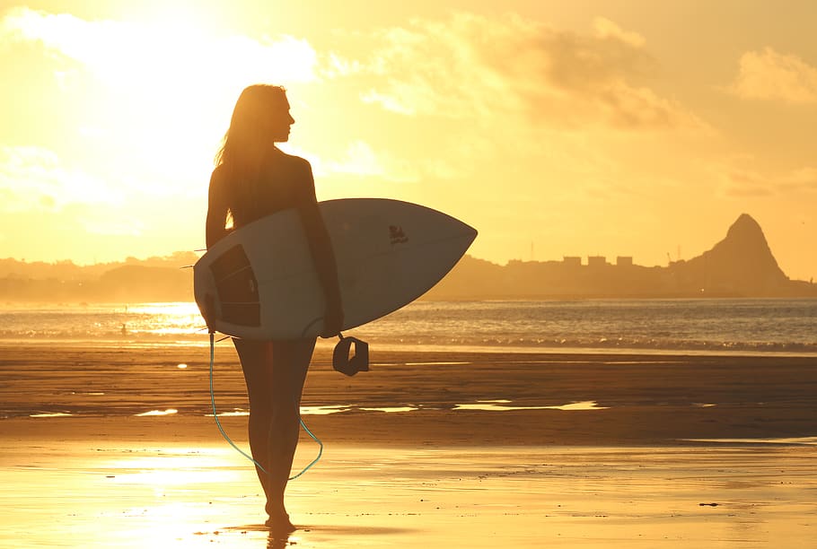 Woman Holding Surf Board Standing on Shoreline during Sunset, HD wallpaper