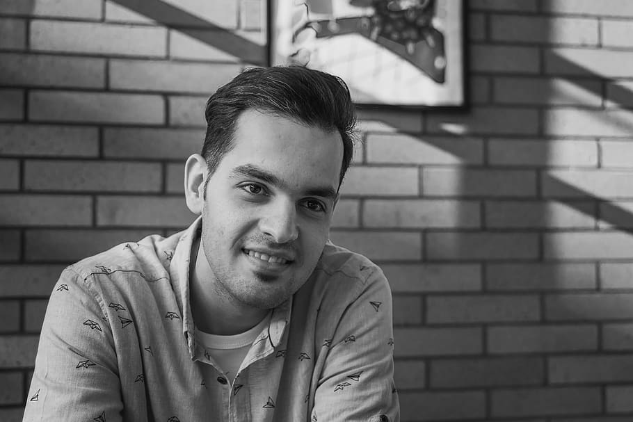 smiling man looking at this left side, portrait, one person, looking at camera HD wallpaper