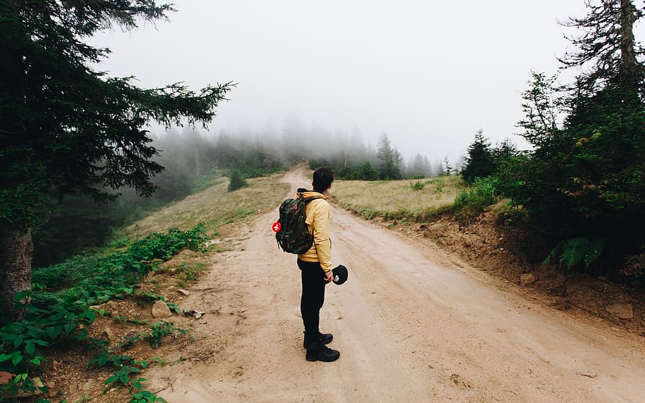 man standing on road during daytime, human, bag, backpack, tree HD wallpaper