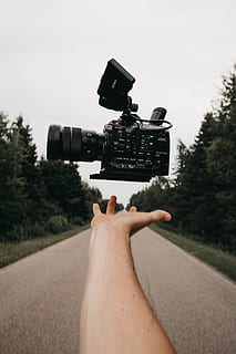 person catching black Sony camcorder, camera, hand, float, levitation HD wallpaper