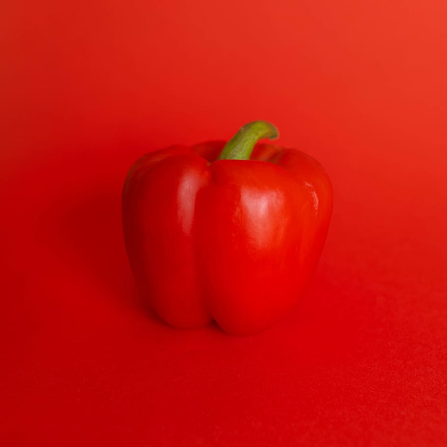 red bell pepper on red surface, food, food and drink, vegetable HD wallpaper