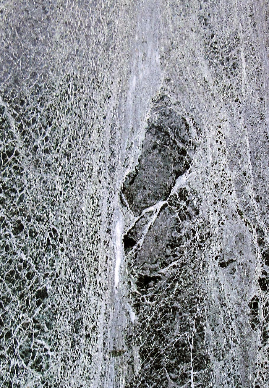 greyscale photo of waterfalls, foam, rug, lace, rock, powder