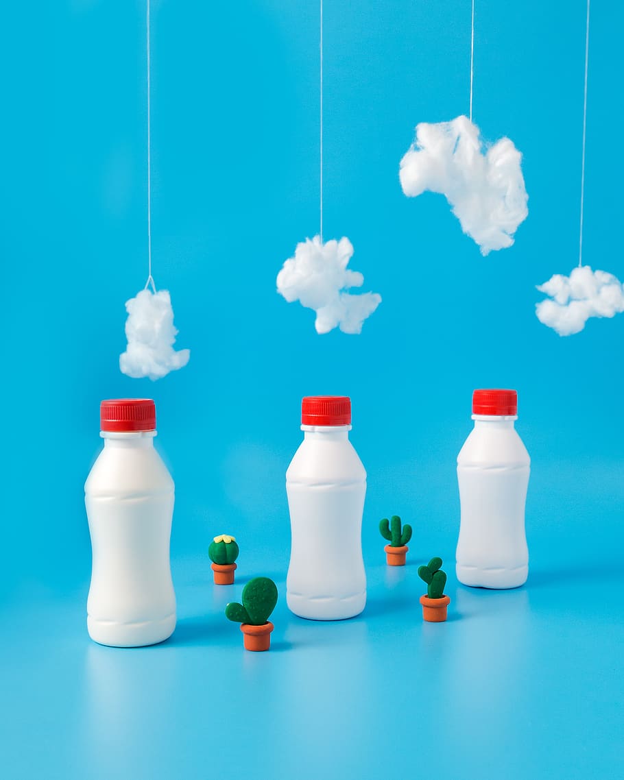 three white plastic bottles under white cottons, studio shot HD wallpaper