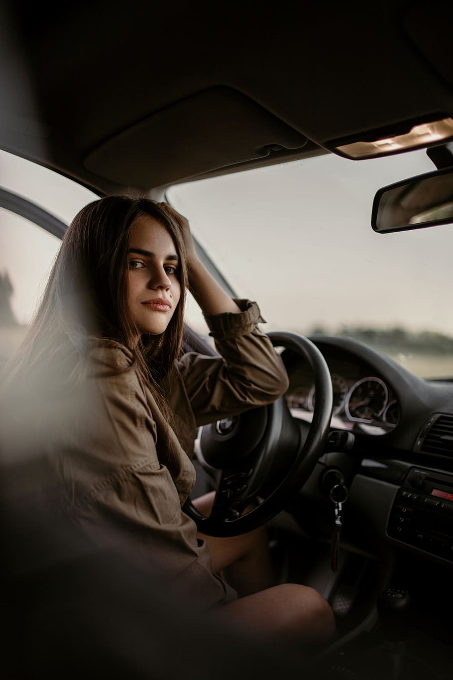woman sitting inside car, female, dashboard, left hand drive