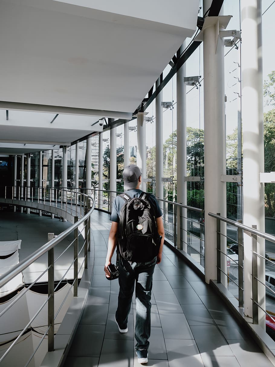 man walking inside the building, banister, handrail, human, person HD wallpaper