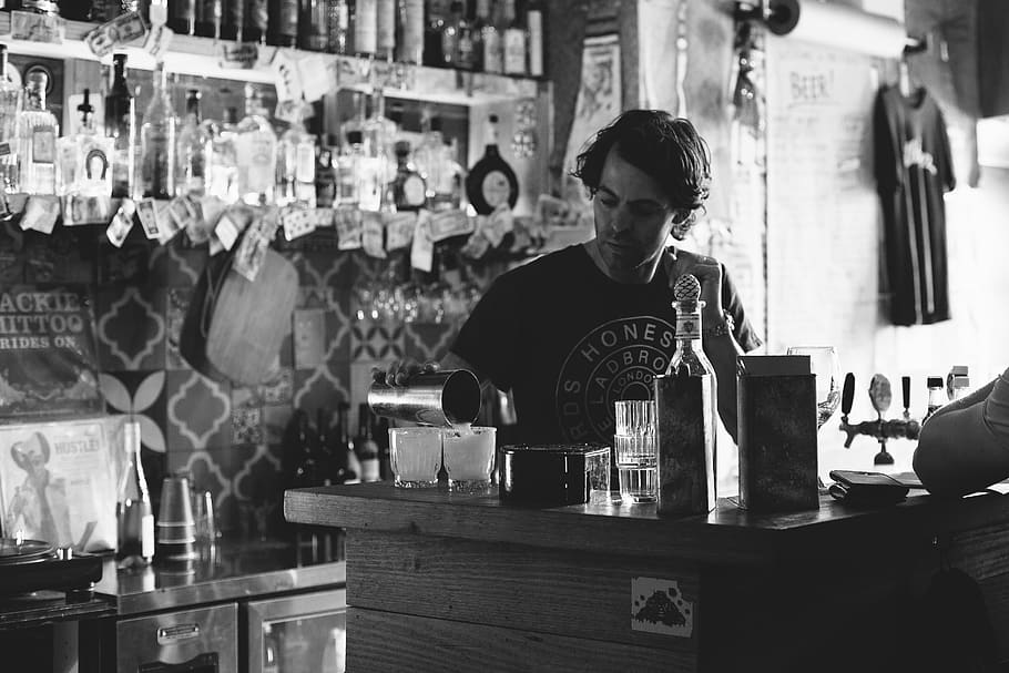 man standing while pouring liquid on cup inside bar, person, human HD wallpaper