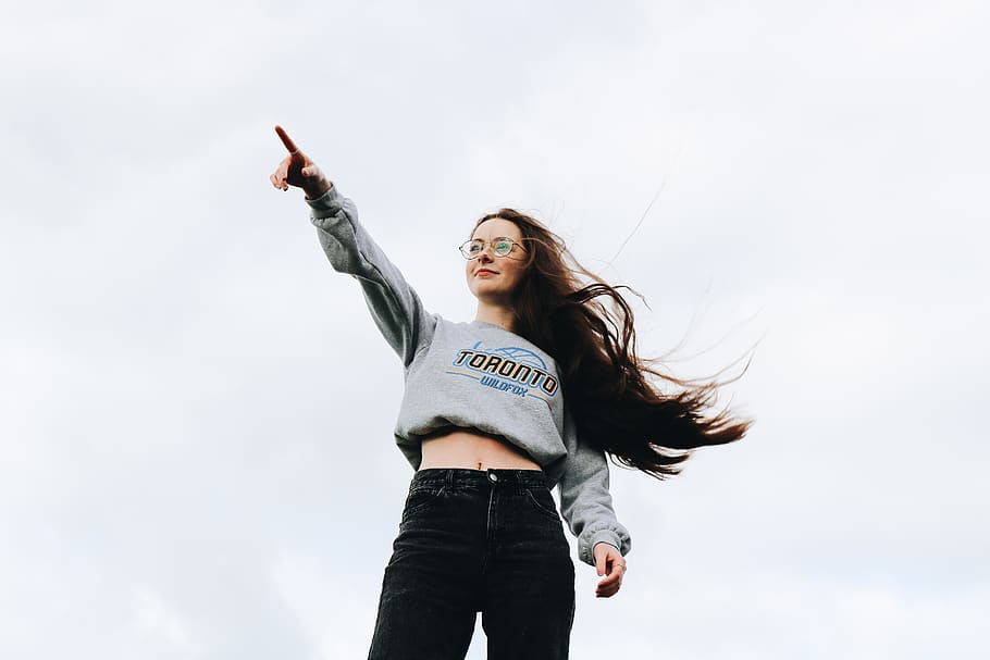 woman pointing using her right hand, young adult, three quarter length HD wallpaper