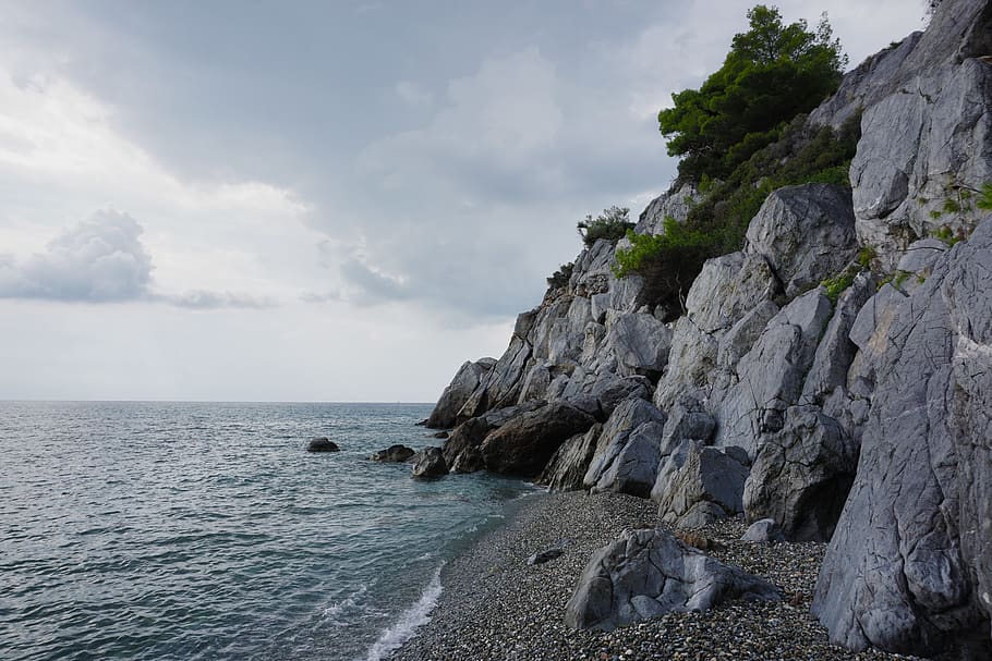 sea, beach, stone, cloudy, water, sky, rock, beauty in nature HD wallpaper
