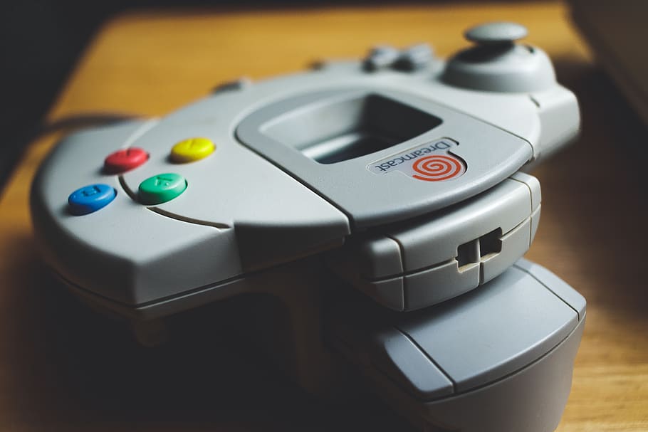 grey game controller on brown wooden table, close-up, technology HD wallpaper