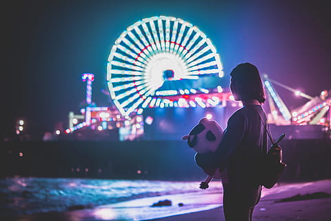 woman standing on shore near themed park during night, fair, beach HD wallpaper
