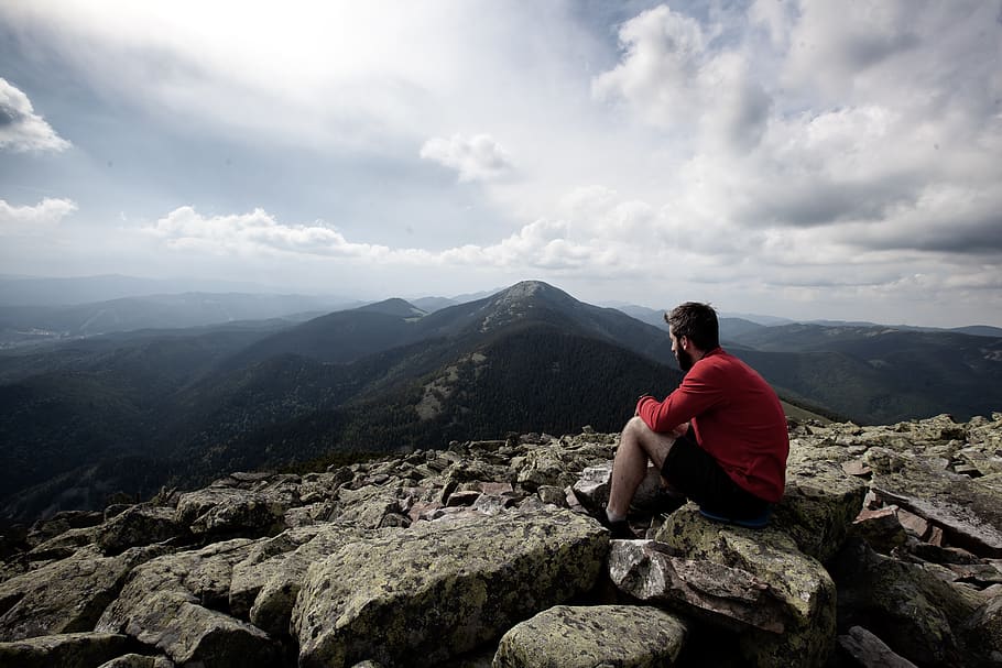 man sitting on rocks, person, human, people, mountain, outdoors HD wallpaper