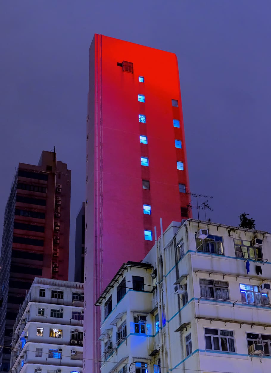 shallow focus photography of red high-rise building at night time