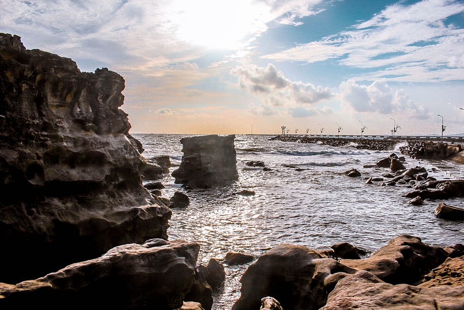 Landscape Photography of Rocks Surrounded by Body of Water, beach HD wallpaper