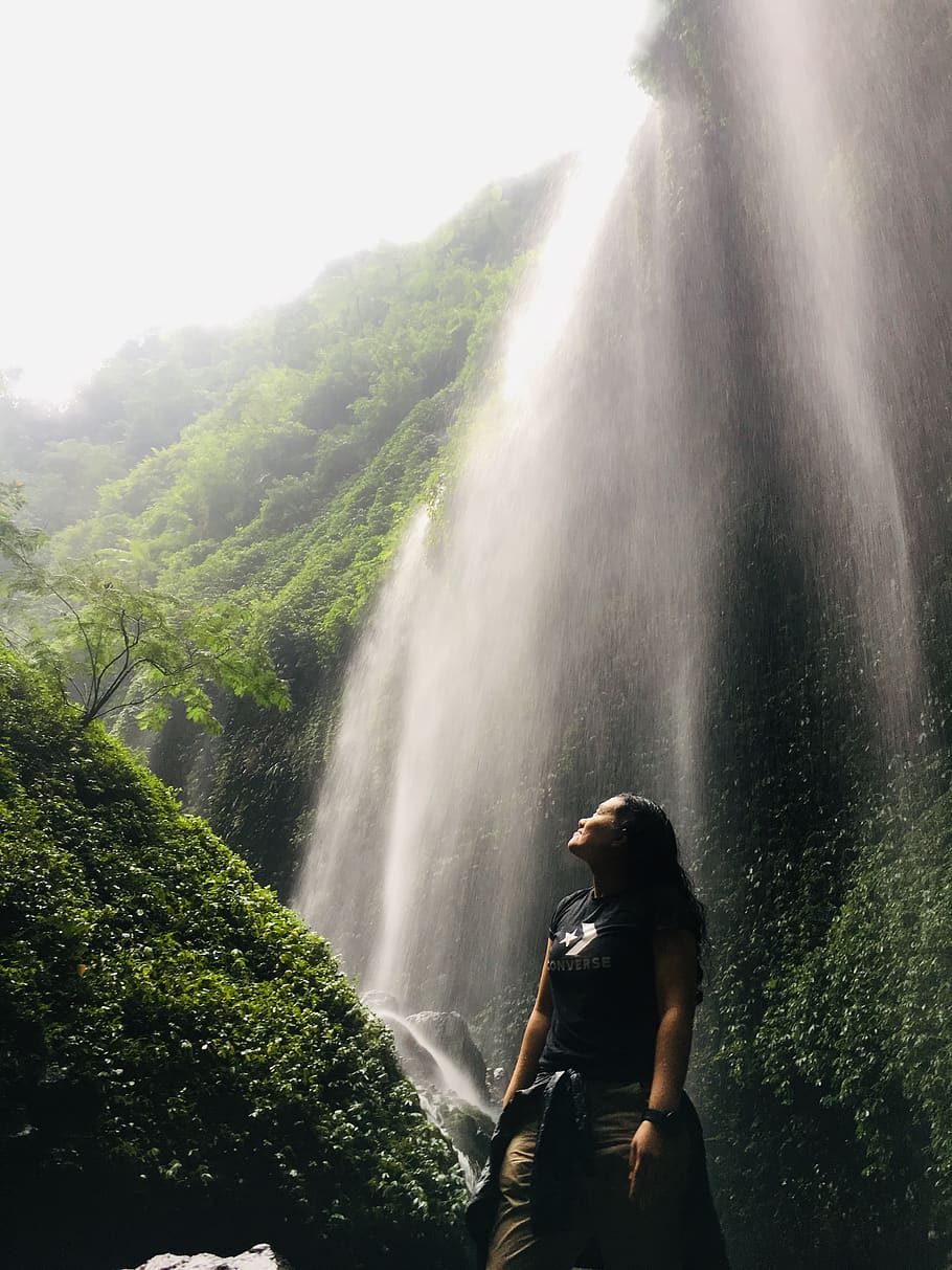 Low Angle Shot Of Woman Standing Under Waterfalls, bromo, eastjava HD wallpaper